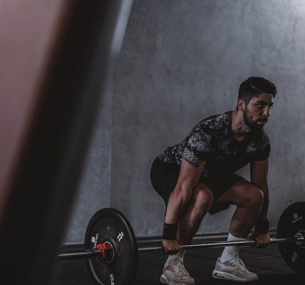 Man lifting weights in gym, displaying strength and focus. Ideal for fitness and training themes.