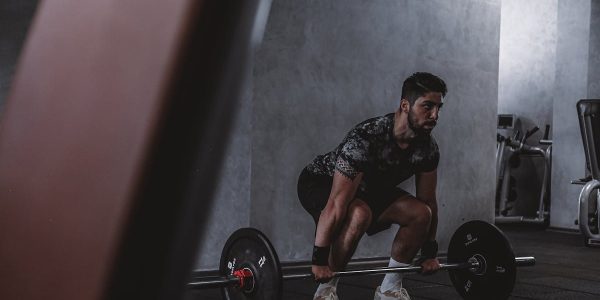 Man lifting weights in gym, displaying strength and focus. Ideal for fitness and training themes.
